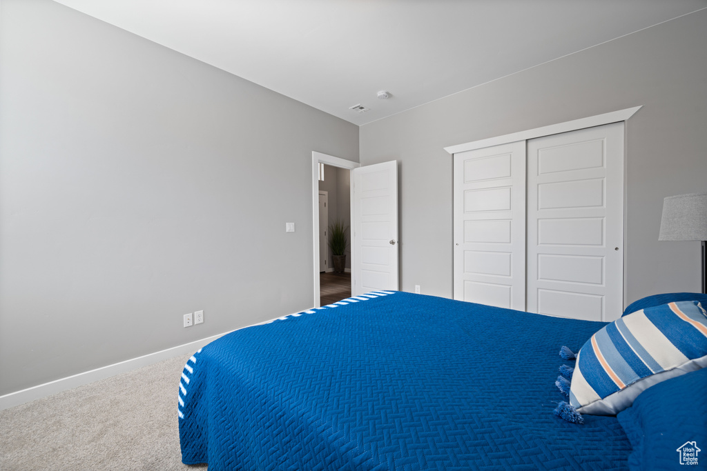 Bedroom featuring a closet and carpet flooring