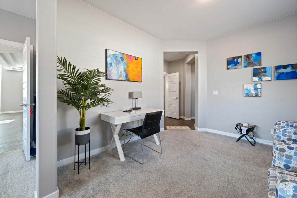 Carpeted office space featuring baseboards