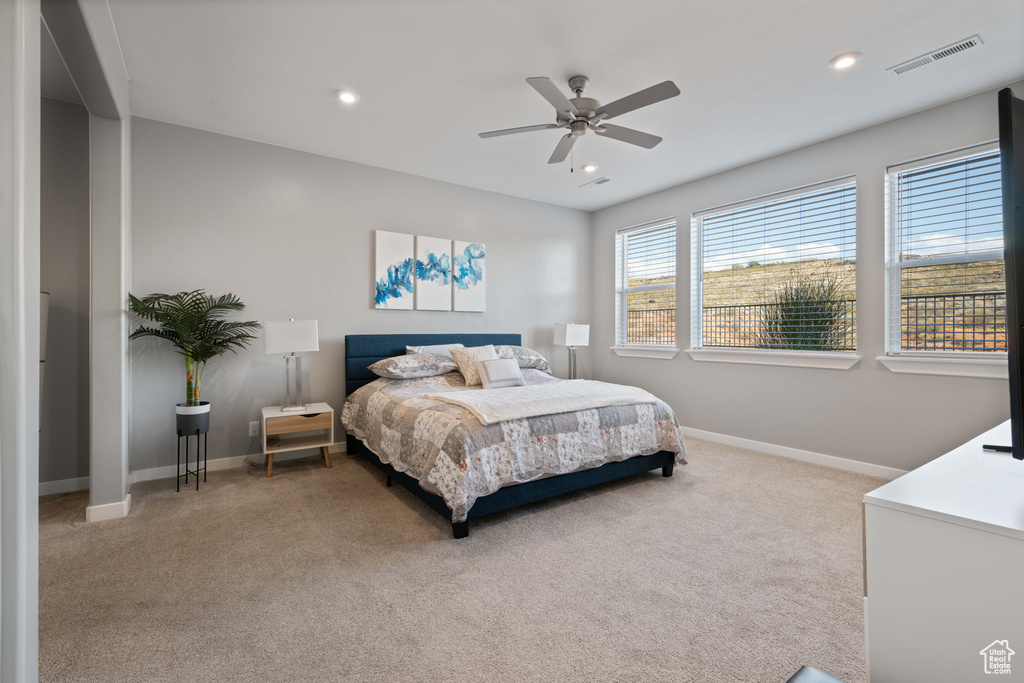 Bedroom with light carpet, recessed lighting, and ceiling fan
