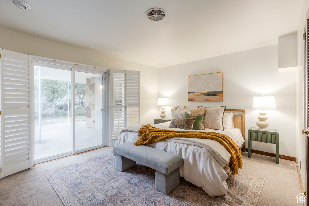 Bedroom featuring access to outside and carpet flooring