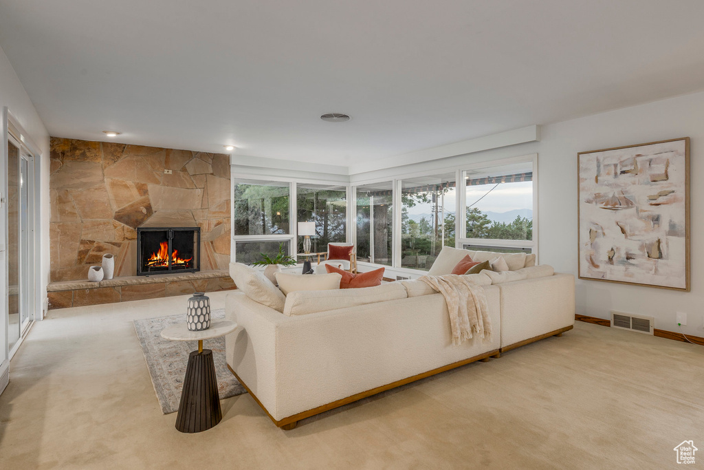 Living room with a fireplace and carpet