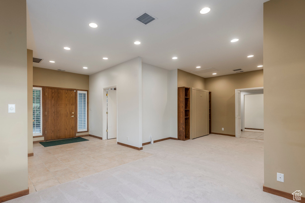 Spare room with light colored carpet and recessed lighting