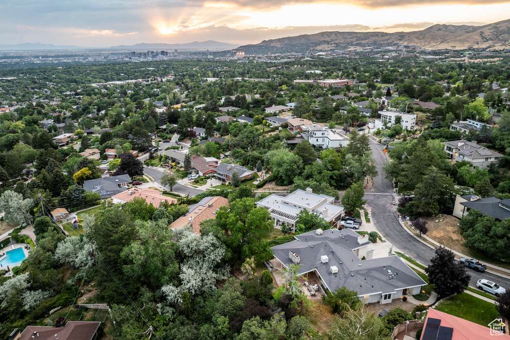 Aerial view of property's location featuring a mountainous background