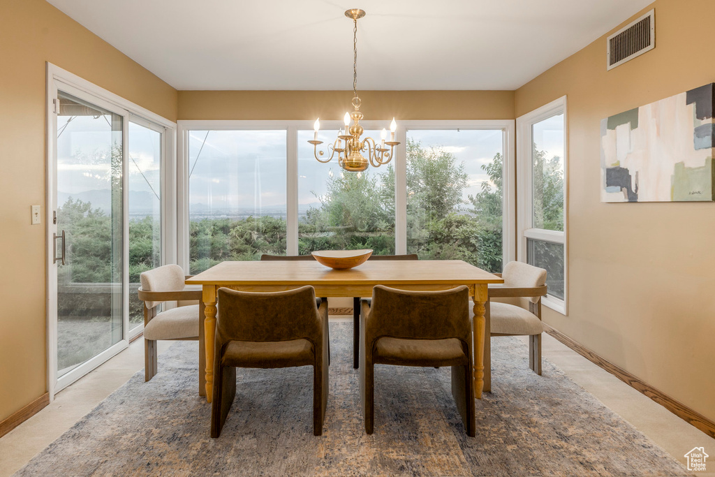 Dining space with a chandelier and baseboards