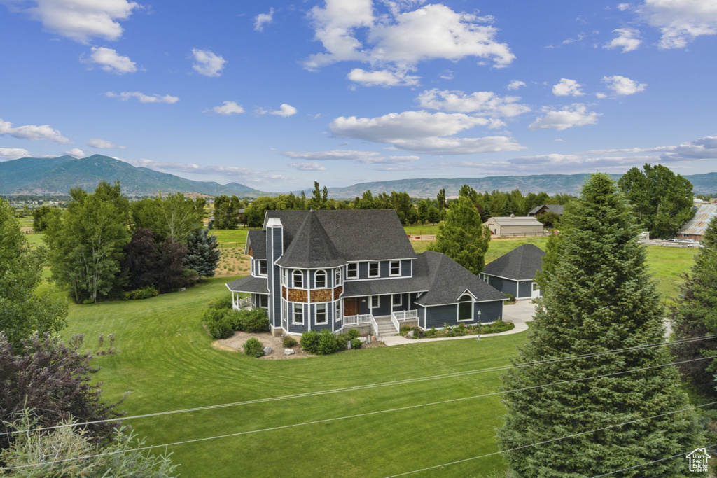Aerial view of property and surrounding area featuring mountains