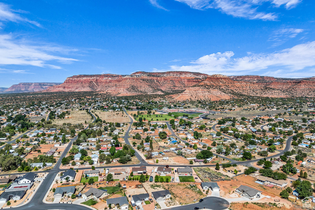 Aerial overview of property's location featuring mountains and nearby suburban area
