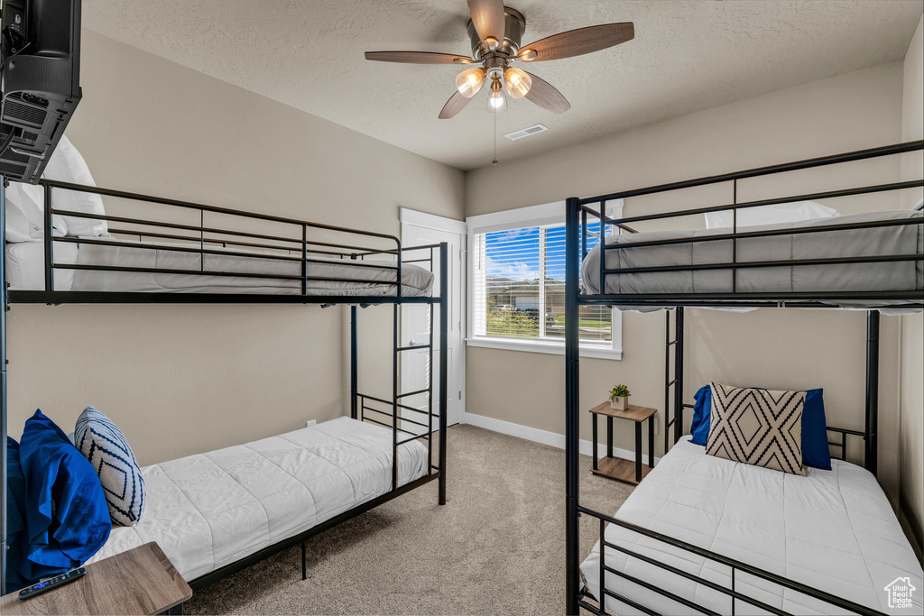 Bedroom with carpet flooring and a textured ceiling