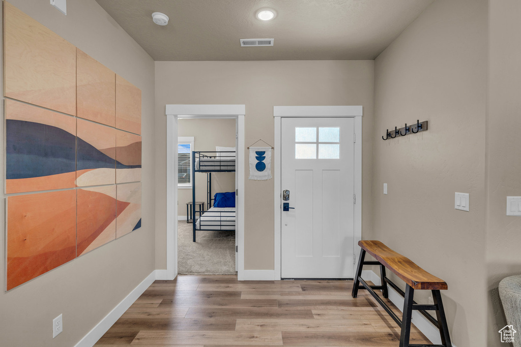 Foyer featuring light wood-type flooring and baseboards