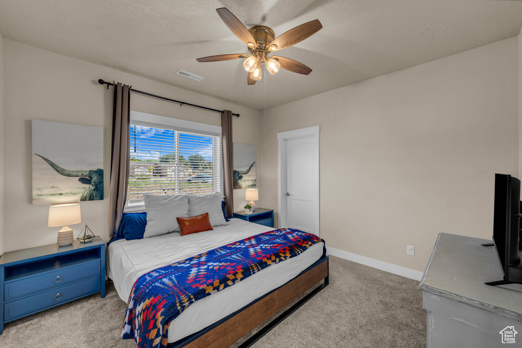 Bedroom featuring light carpet and a ceiling fan