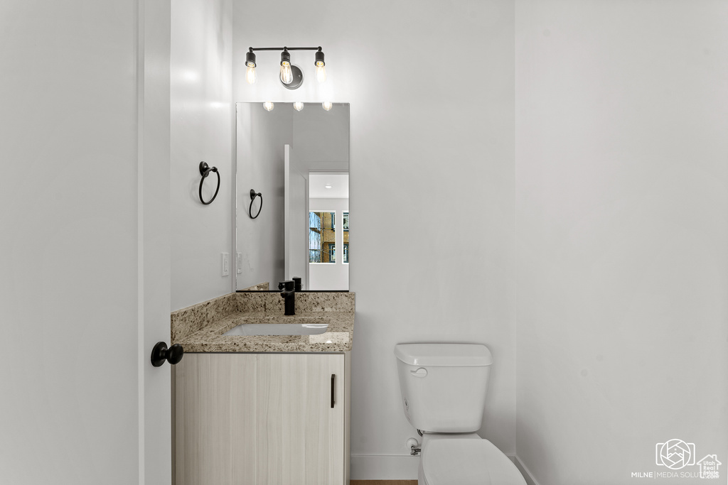 Half bathroom with toilet and vanity