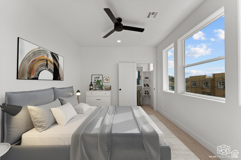 Bedroom featuring light carpet, ceiling fan, and recessed lighting