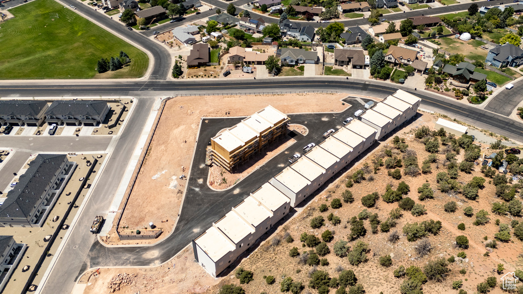 Aerial view of property and surrounding area with nearby suburban area