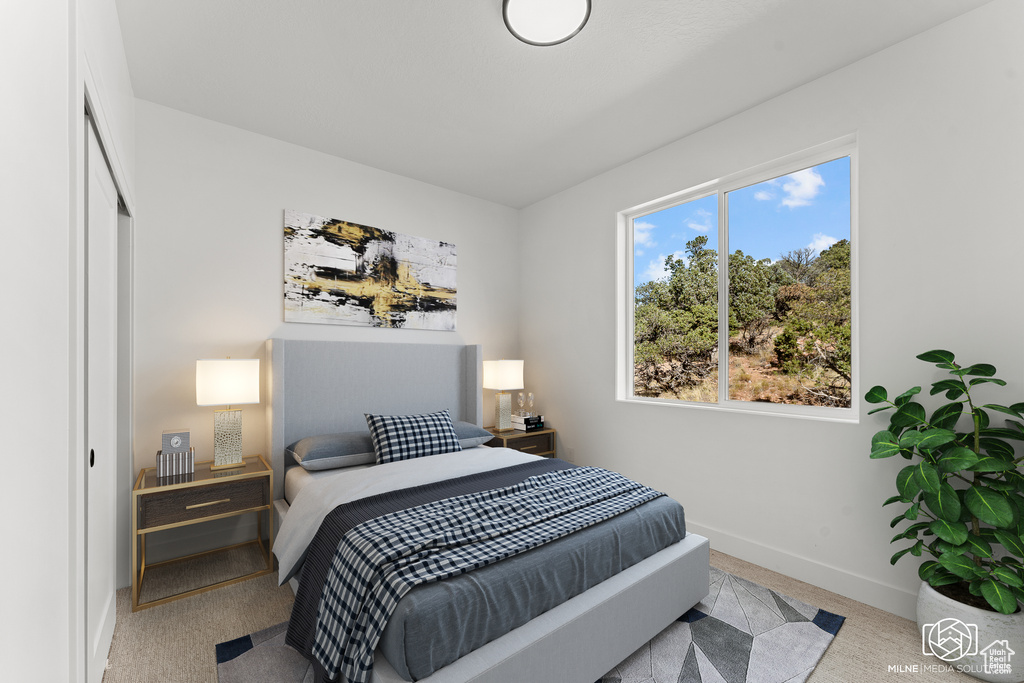Carpeted bedroom featuring baseboards