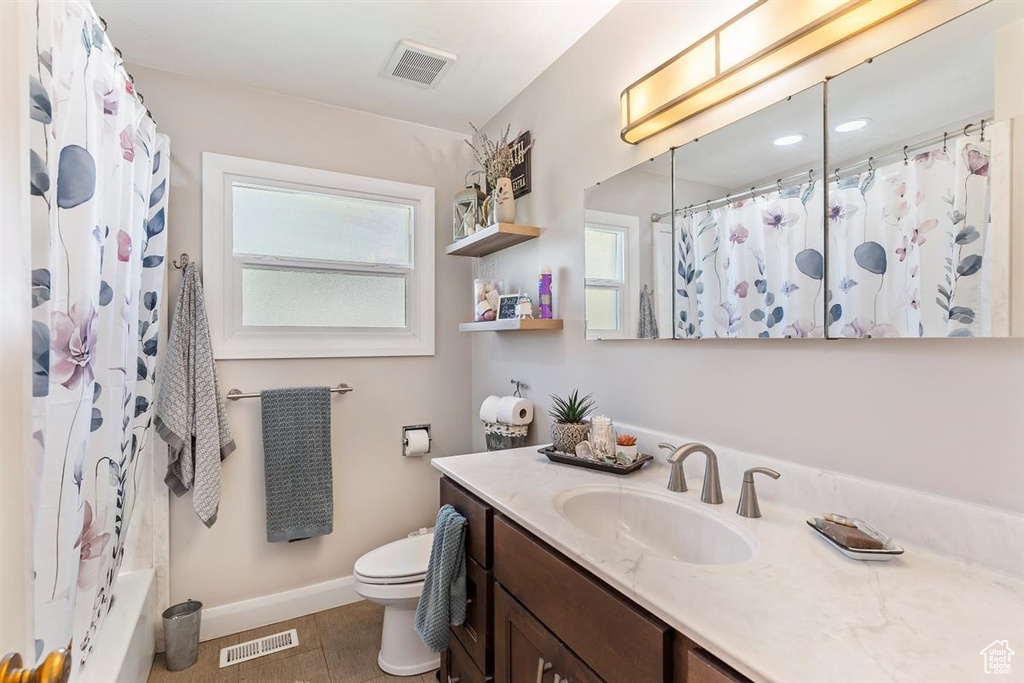Bathroom with vanity and a shower with shower curtain