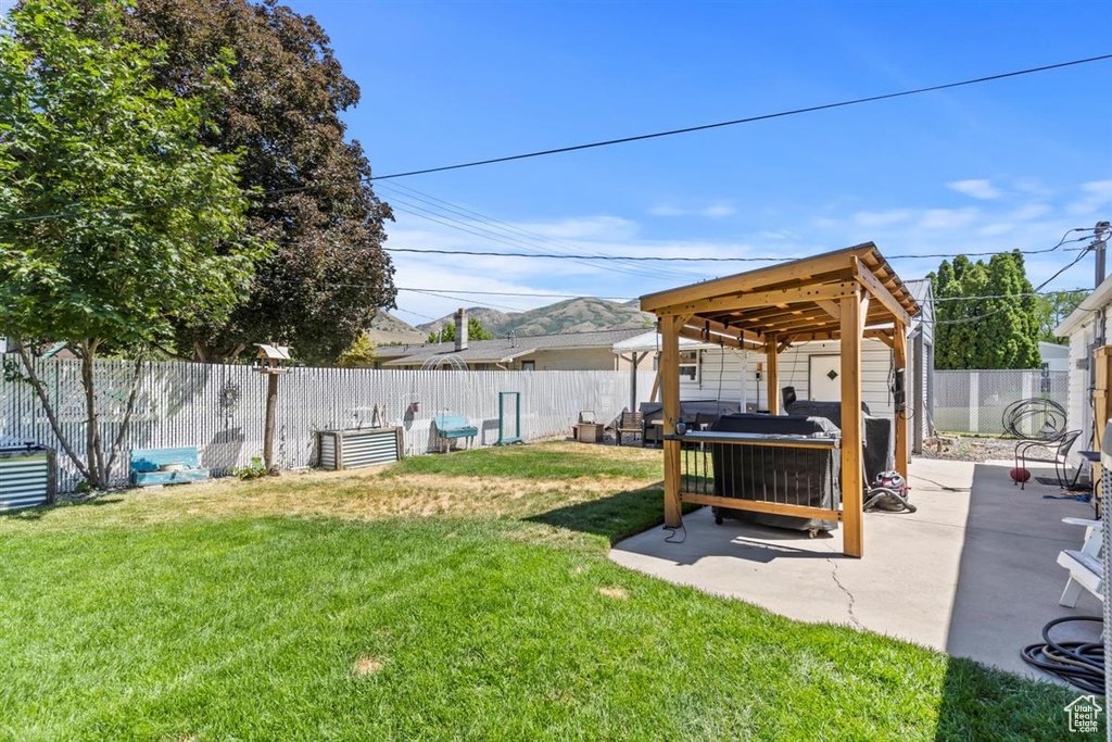 Fenced backyard with a patio