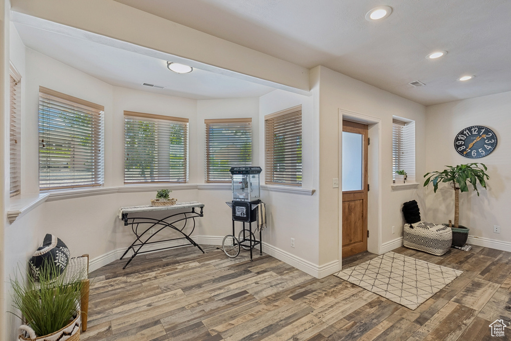Entryway with wood finished floors and recessed lighting