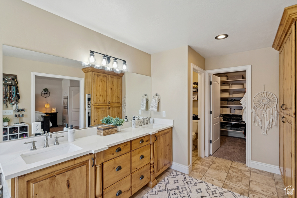 Full bath featuring double vanity and recessed lighting