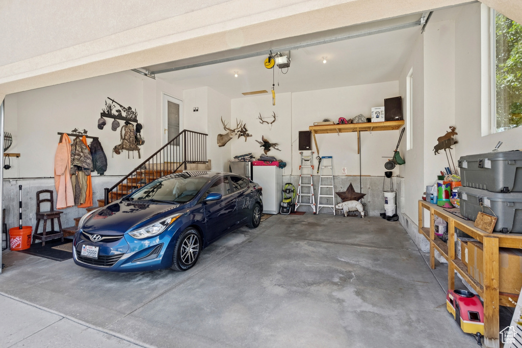 Garage featuring a garage door opener