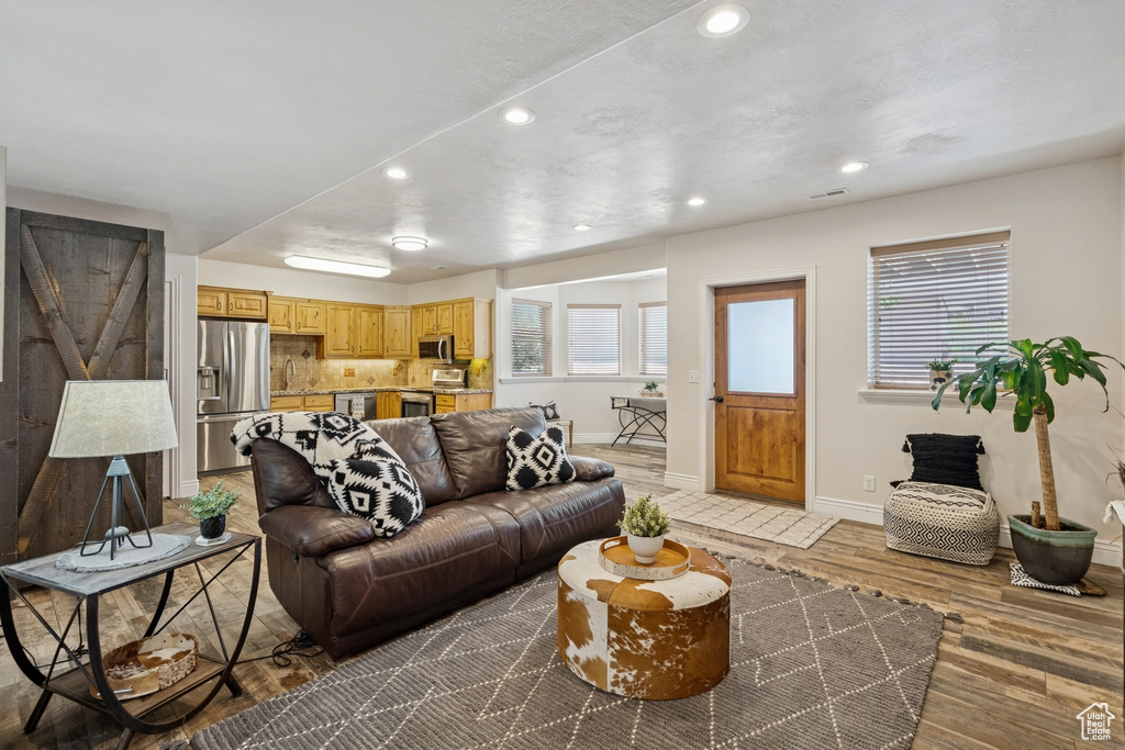 Living area with recessed lighting and wood finished floors