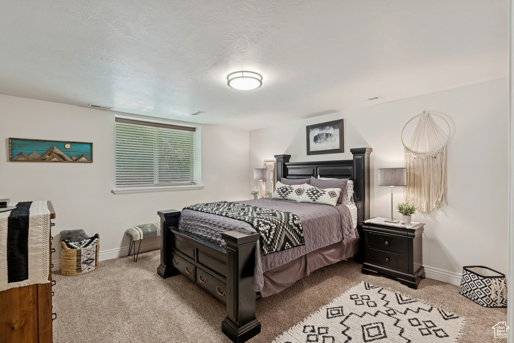 Carpeted bedroom featuring baseboards
