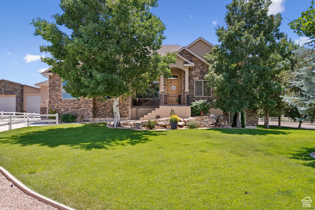 Obstructed view of property with stone siding and stucco siding