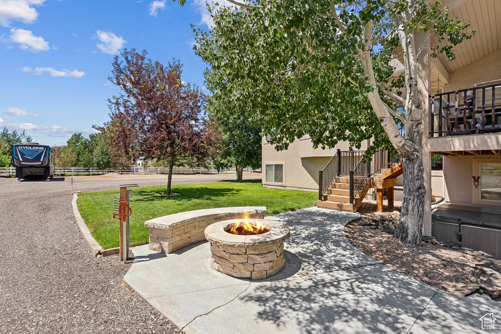 View of patio / terrace featuring an outdoor fire pit and stairway
