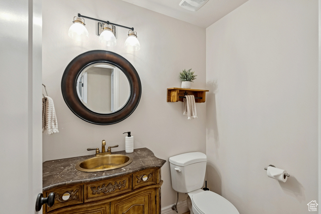 Half bathroom with toilet and vanity