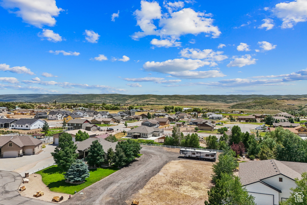 Aerial view of residential area featuring a mountainous background