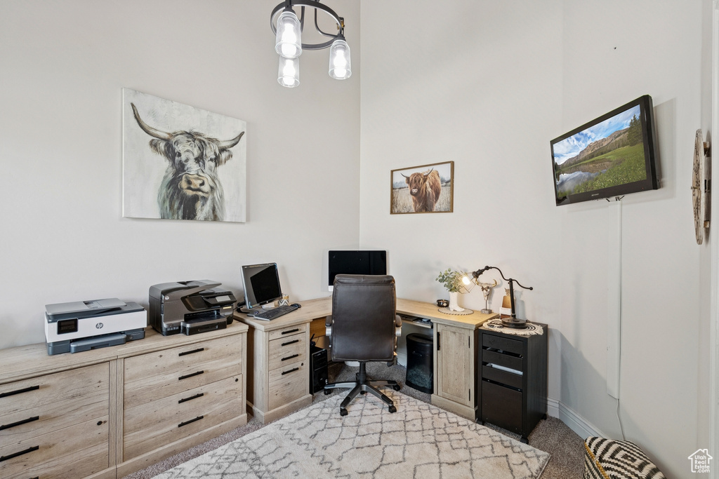 Carpeted office space with baseboards