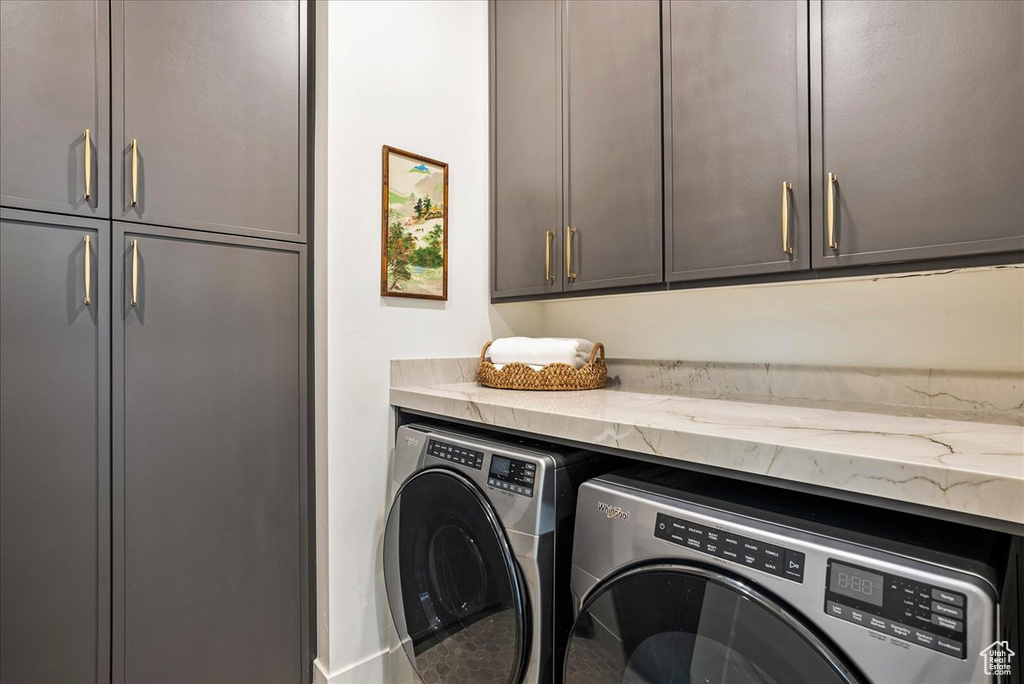 Laundry area featuring cabinet space and washer and dryer