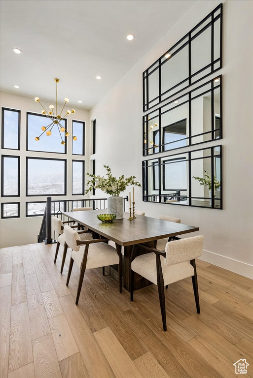 Dining room featuring light wood-style floors, a chandelier, and recessed lighting