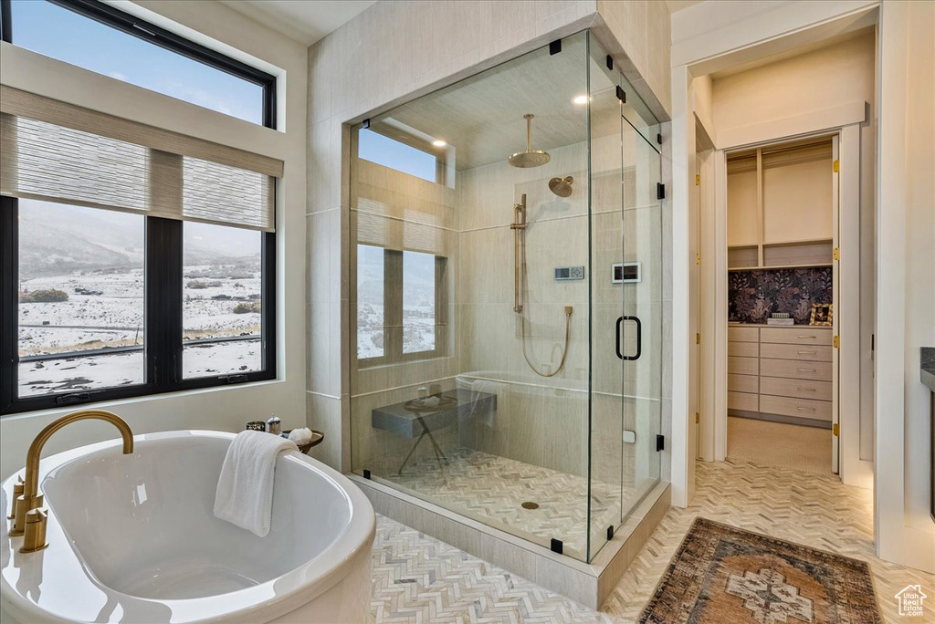 Bathroom featuring a shower stall and a soaking tub