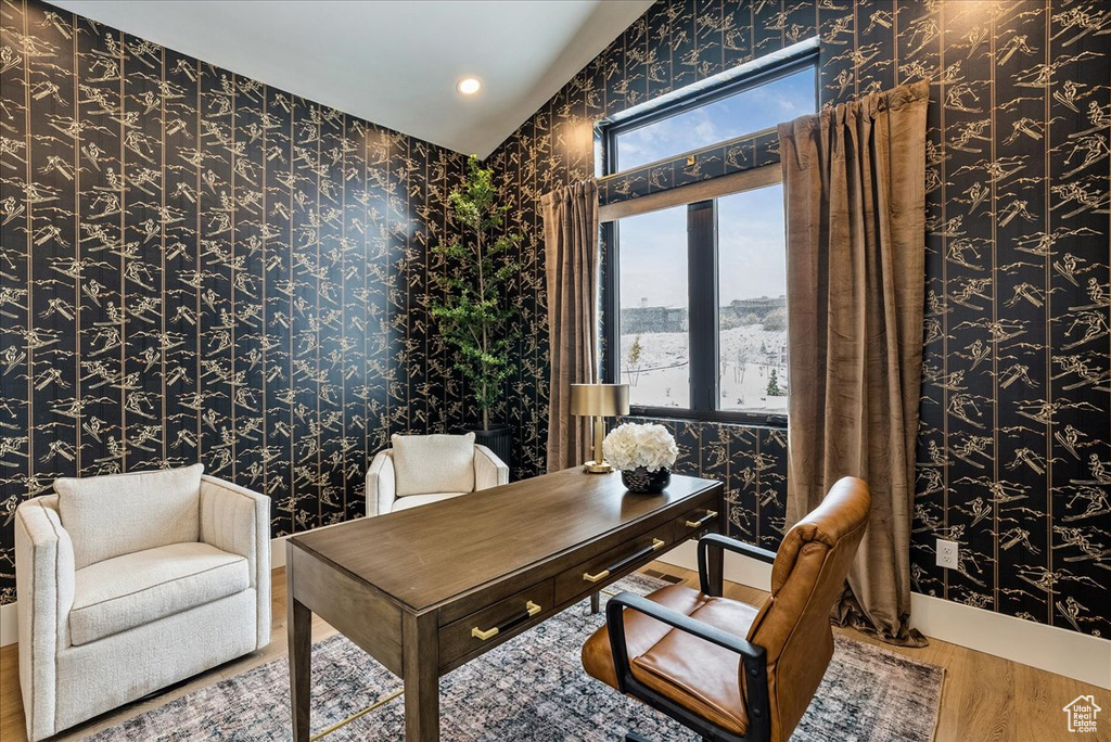 Home office featuring wallpapered walls, wood finished floors, and recessed lighting