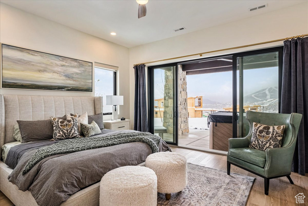 Bedroom with access to exterior, light wood-type flooring, recessed lighting, and ceiling fan