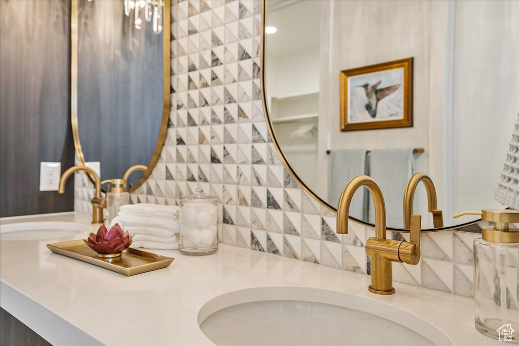 Bathroom view of double vanity and decorative backsplash