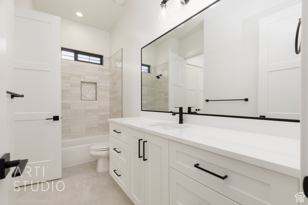 Bathroom with vanity, washtub / shower combination, and recessed lighting