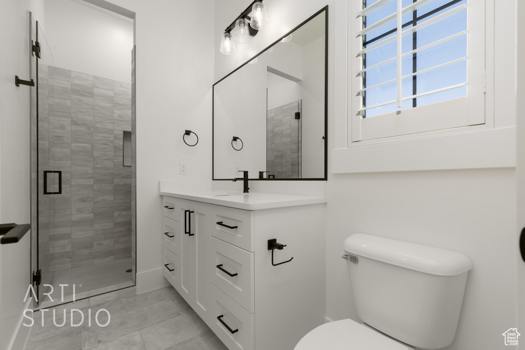 Full bathroom with vanity and a stall shower