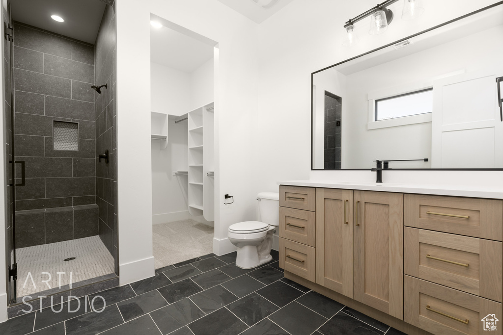 Full bathroom featuring a stall shower and vanity