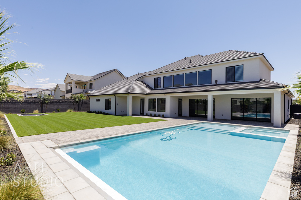 View of swimming pool with a pool with connected hot tub and a patio