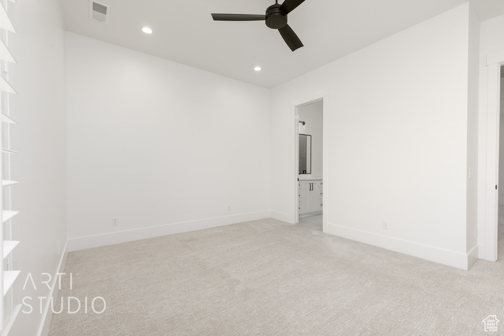 Empty room featuring a ceiling fan, light colored carpet, and recessed lighting