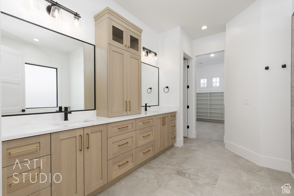 Bathroom featuring double vanity, a closet, and recessed lighting