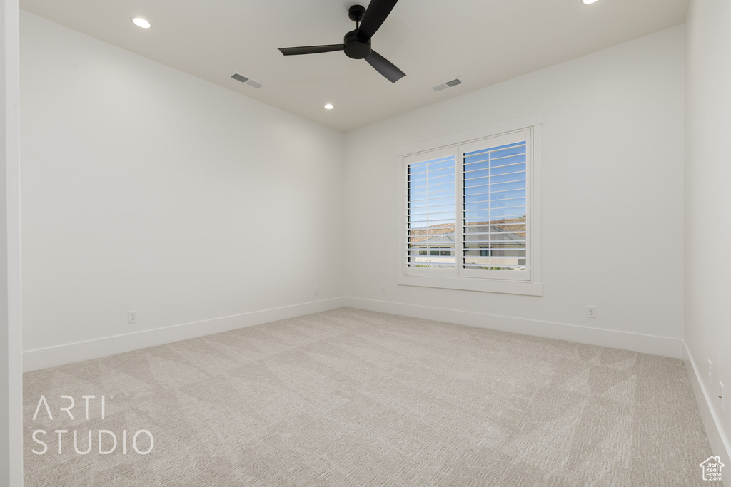 Empty room featuring carpet, ceiling fan, and recessed lighting