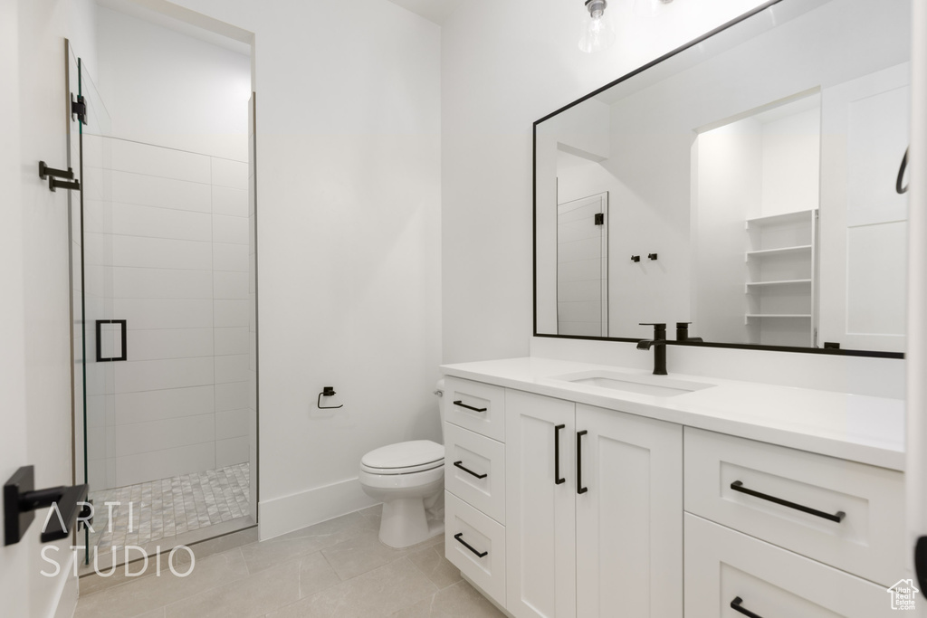 Bathroom featuring vanity, a stall shower, and tile patterned flooring