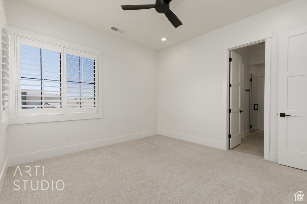 Carpeted empty room featuring ceiling fan and recessed lighting