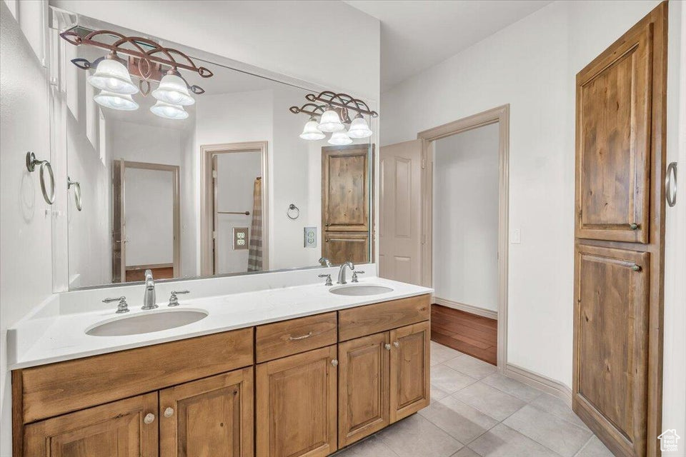 Bathroom featuring double vanity and tile patterned flooring