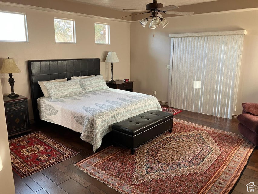 Bedroom featuring wood-type flooring and ceiling fan