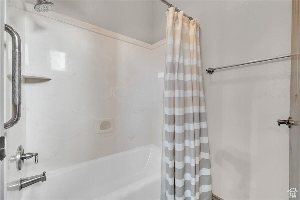 Bathroom featuring shower / bath combo with shower curtain