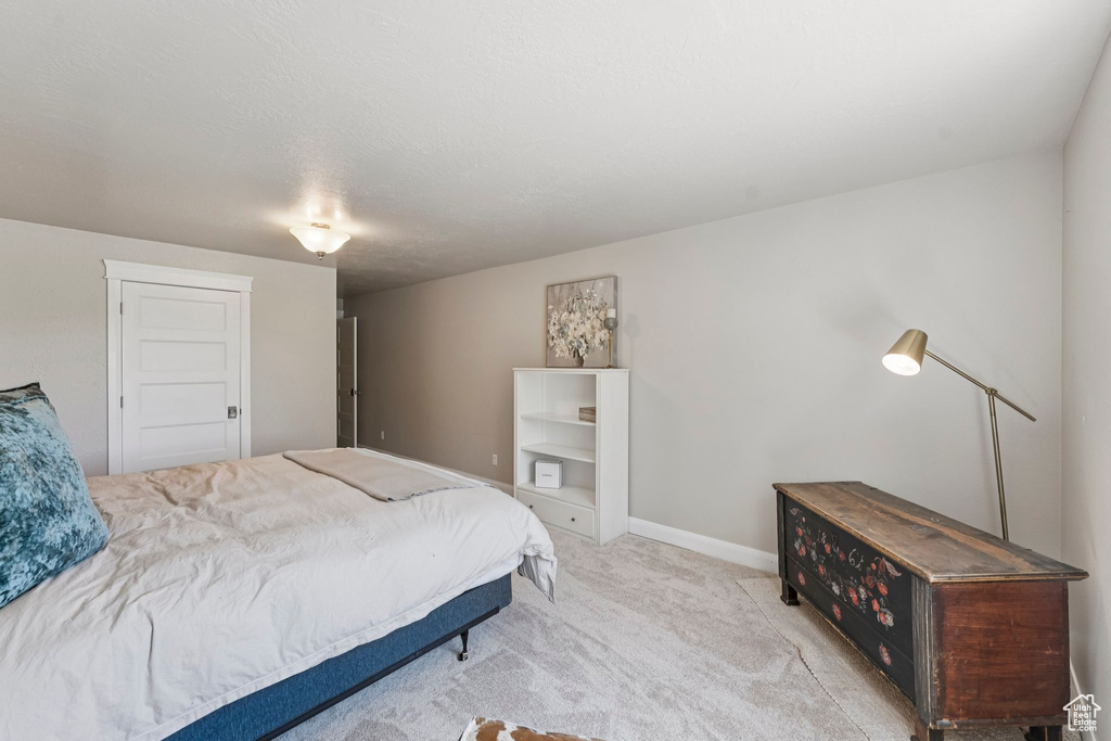 Carpeted bedroom featuring baseboards