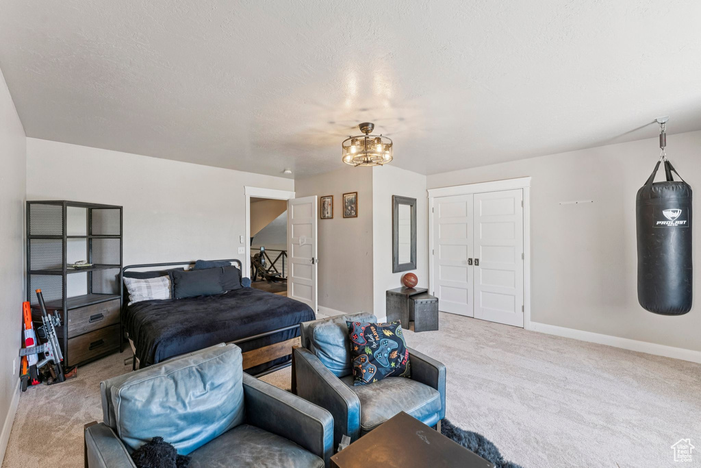 Bedroom with light carpet and a closet