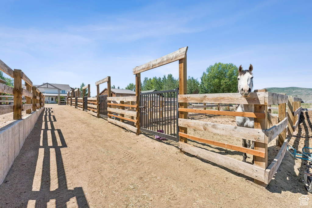 View of dirt / gravel driveway featuring an exterior structure